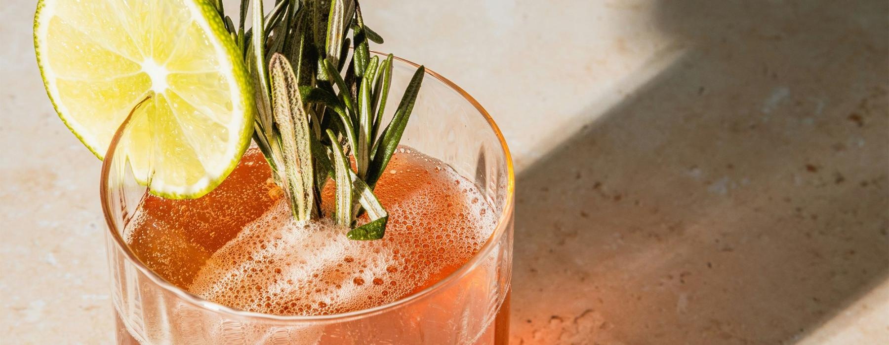 a glass with a drink and a lemon on top