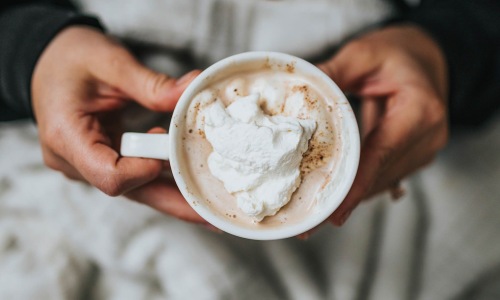 a person holding a coffee mug