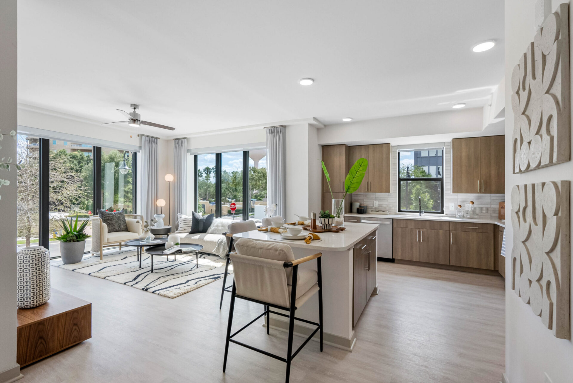 Elegant living room and kitchen view within a residence at The CenterPointe Apartments in Altamonte Springs near Orlando