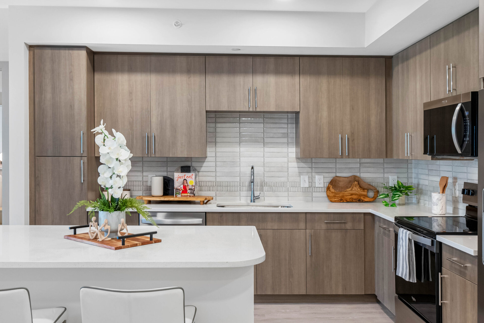 Kitchen with oak cabinets and large island at The CenterPointe in Orlando, FL